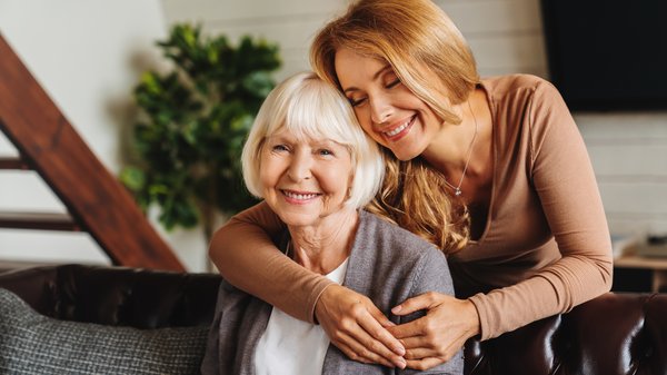 memory-care-young-woman-hugging-elderly-mother