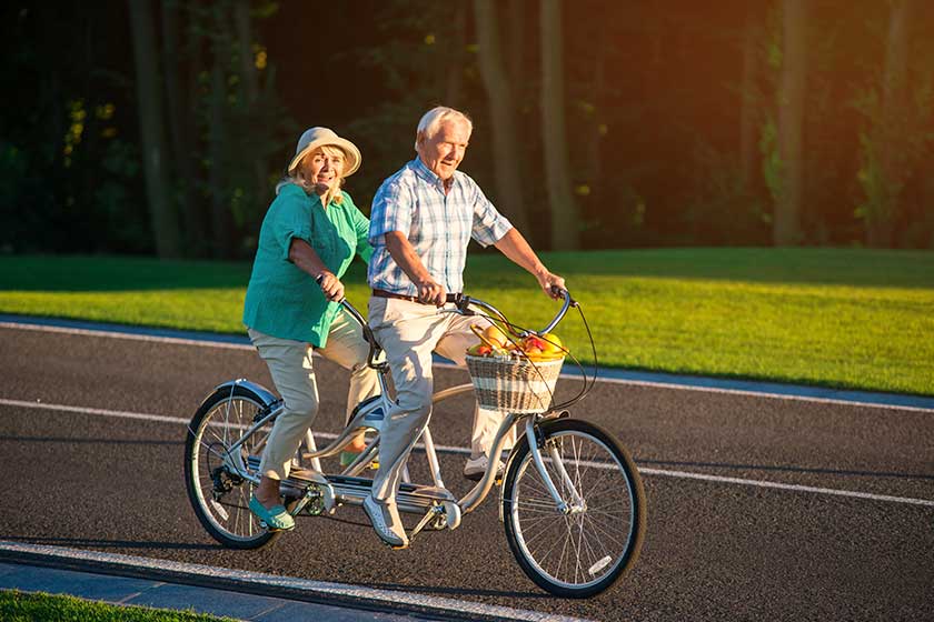 Senior couple rides tandem bike