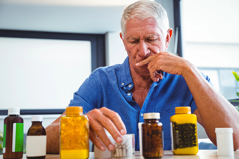 Senior man holding medicine