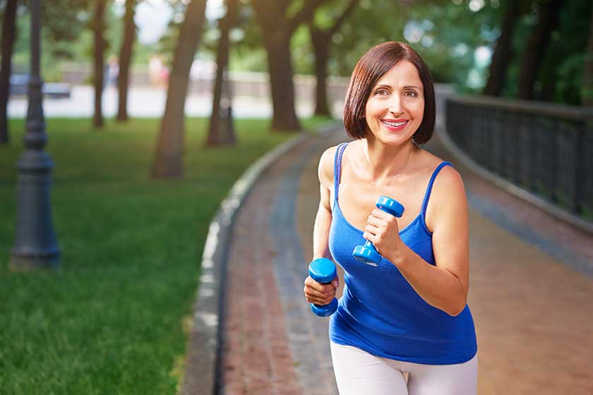 Woman running with bar bells